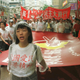Pro-democracy activists of Hong Kong Alliance carry a red banner reading "Democracy for Hong Kong" during their march in a street in Hong Kong, China, Tuesday, July 1, 1997. Democrats held the first large post-handover protest under the Chinese rule. (AP Photo/David Brauchli)